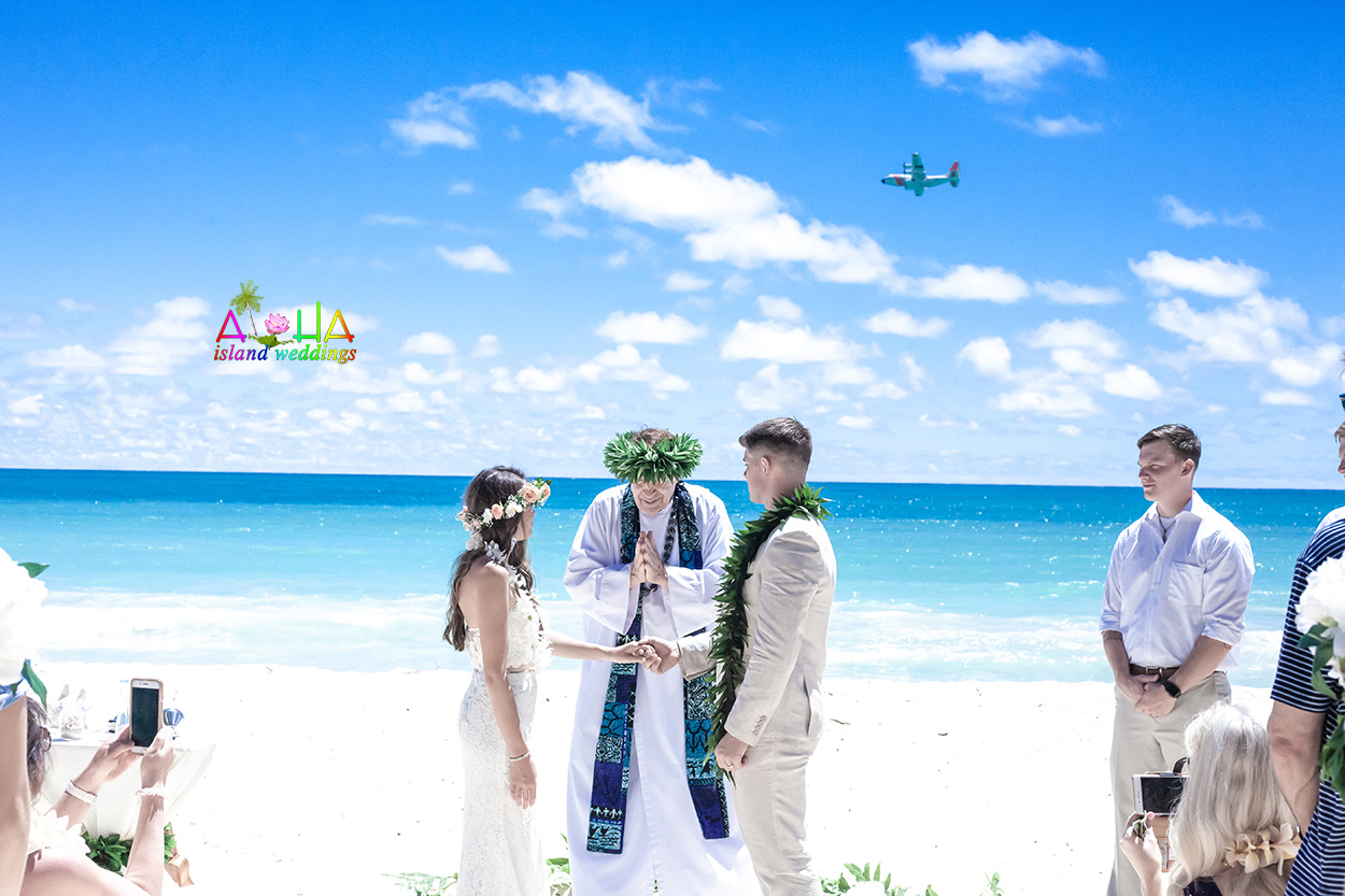 Bride Megan, her groom and minister Alan Fisher at their beach wedding by the ocean